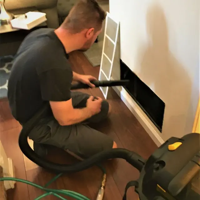 M&H technician working on residential ductwork